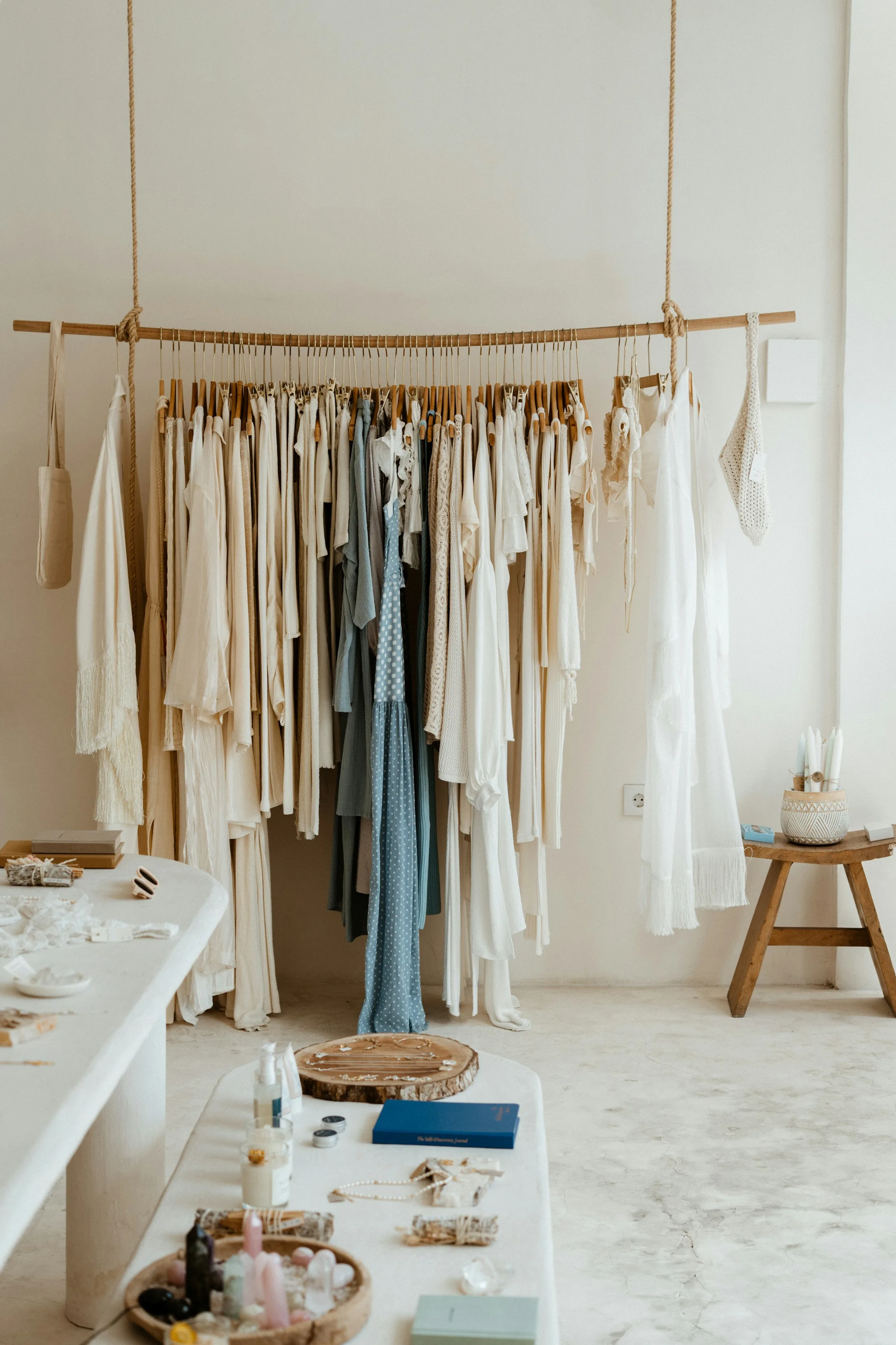 Light dresses hanging on a curated boutique rack