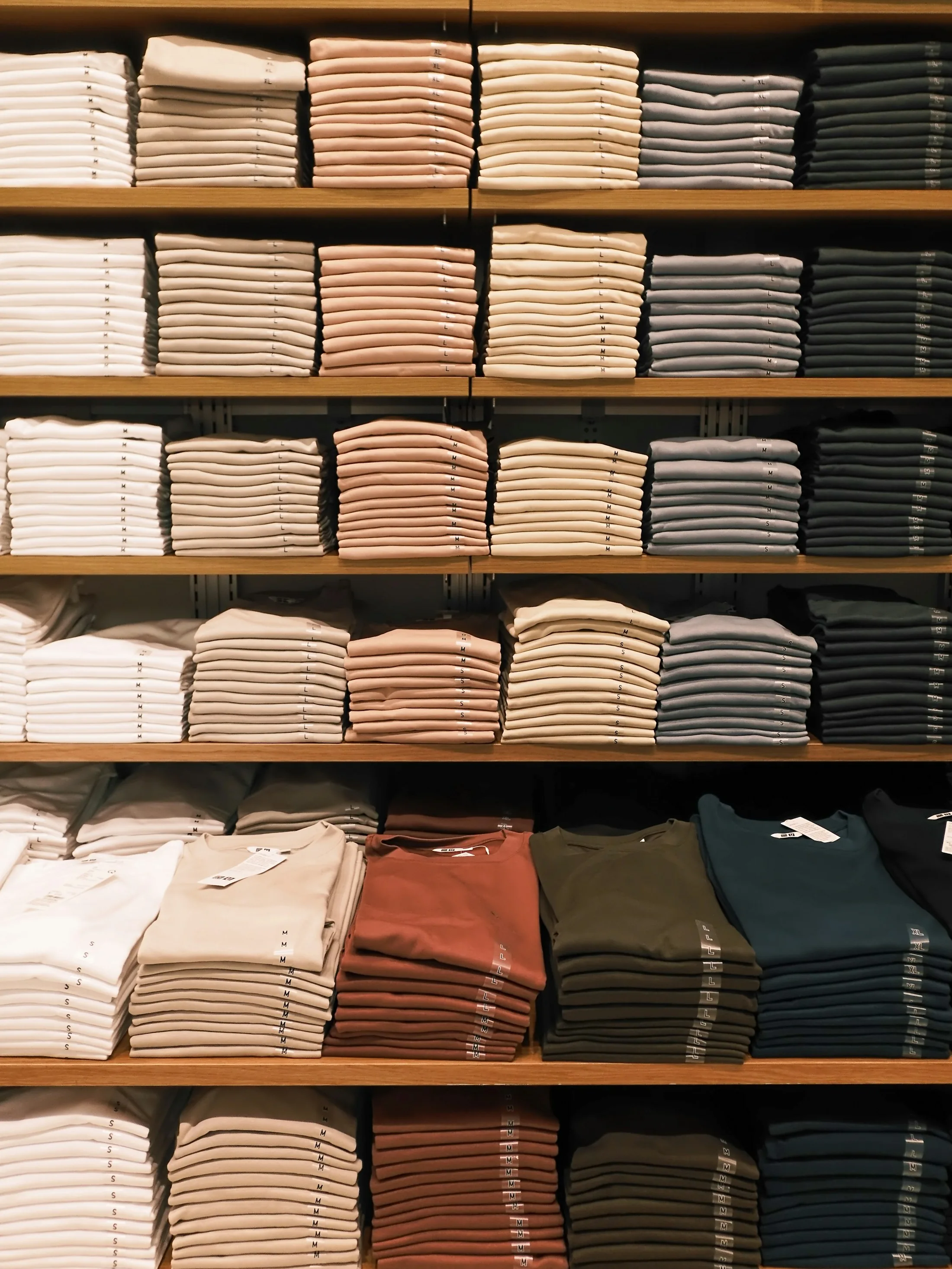 Neatly folded apparel displayed on shelves